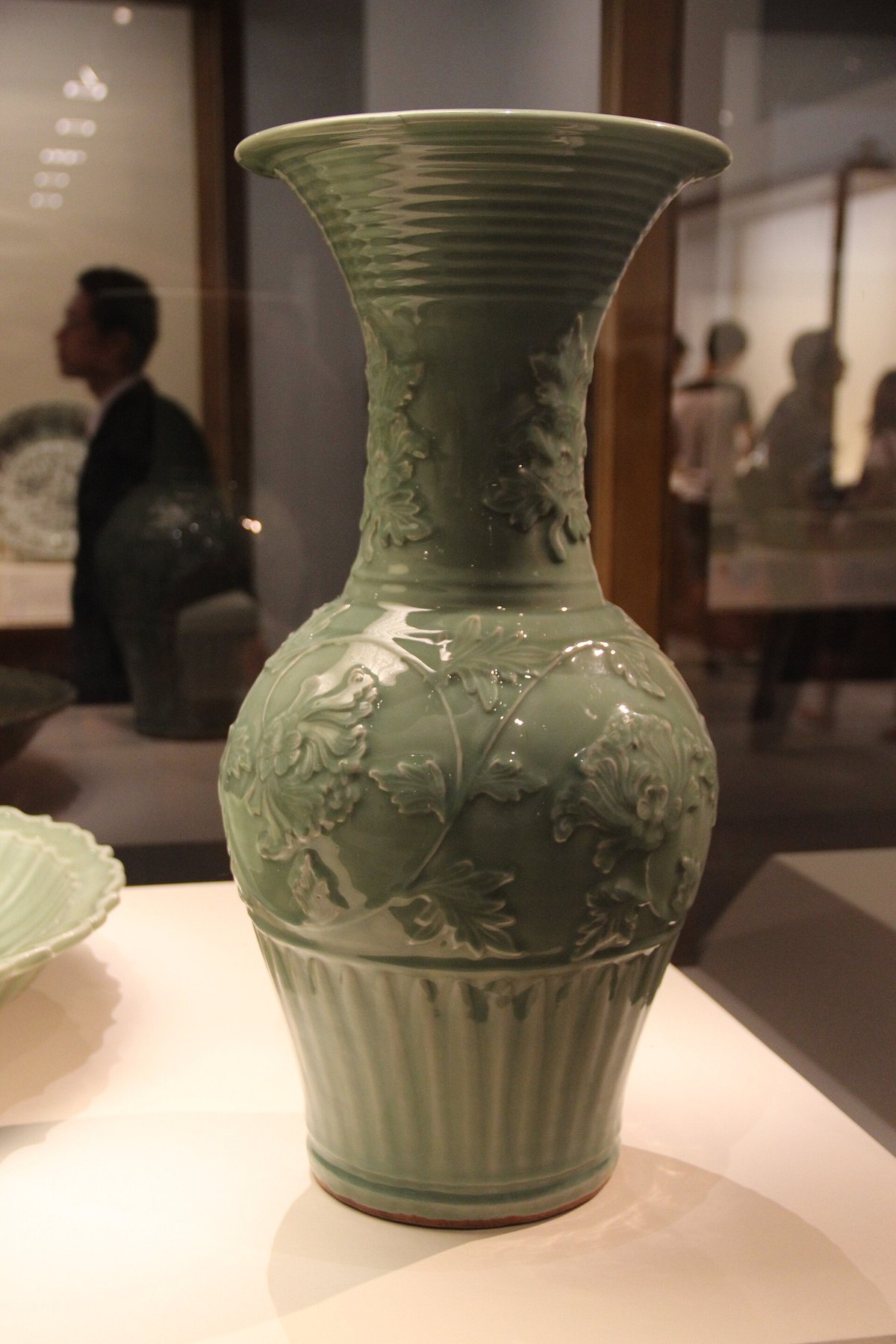 Historic Longquan celadon vase photographed in a museum exhibition; not a photograph of a present-day Longquan studio.